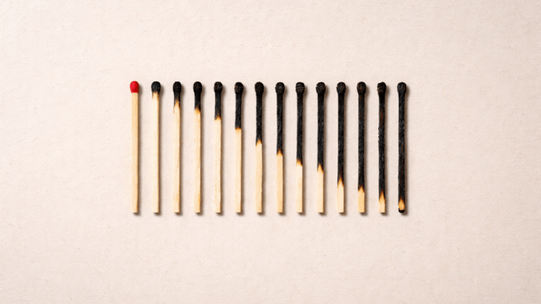 A row of wooden matches gradually burned from left to right on a neutral beige background