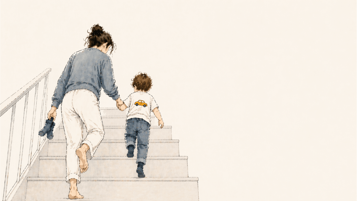 Mother and young child seen from behind climbing a staircase together, holding hands; she carries small blue socks while the child wears a white T-shirt with a yellow car, in a soft, warm-toned editorial ink illustration.